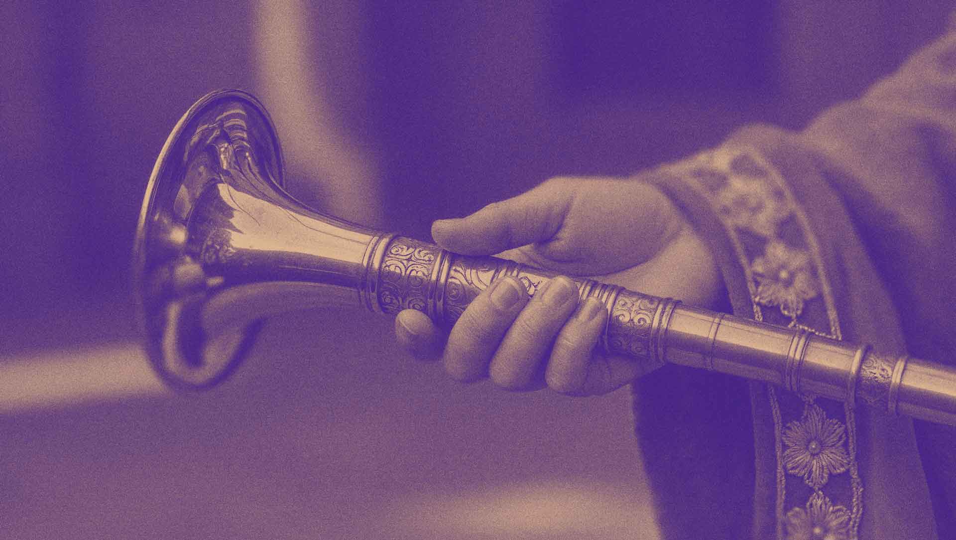 In her right hand she bare a trumpet of beaten gold